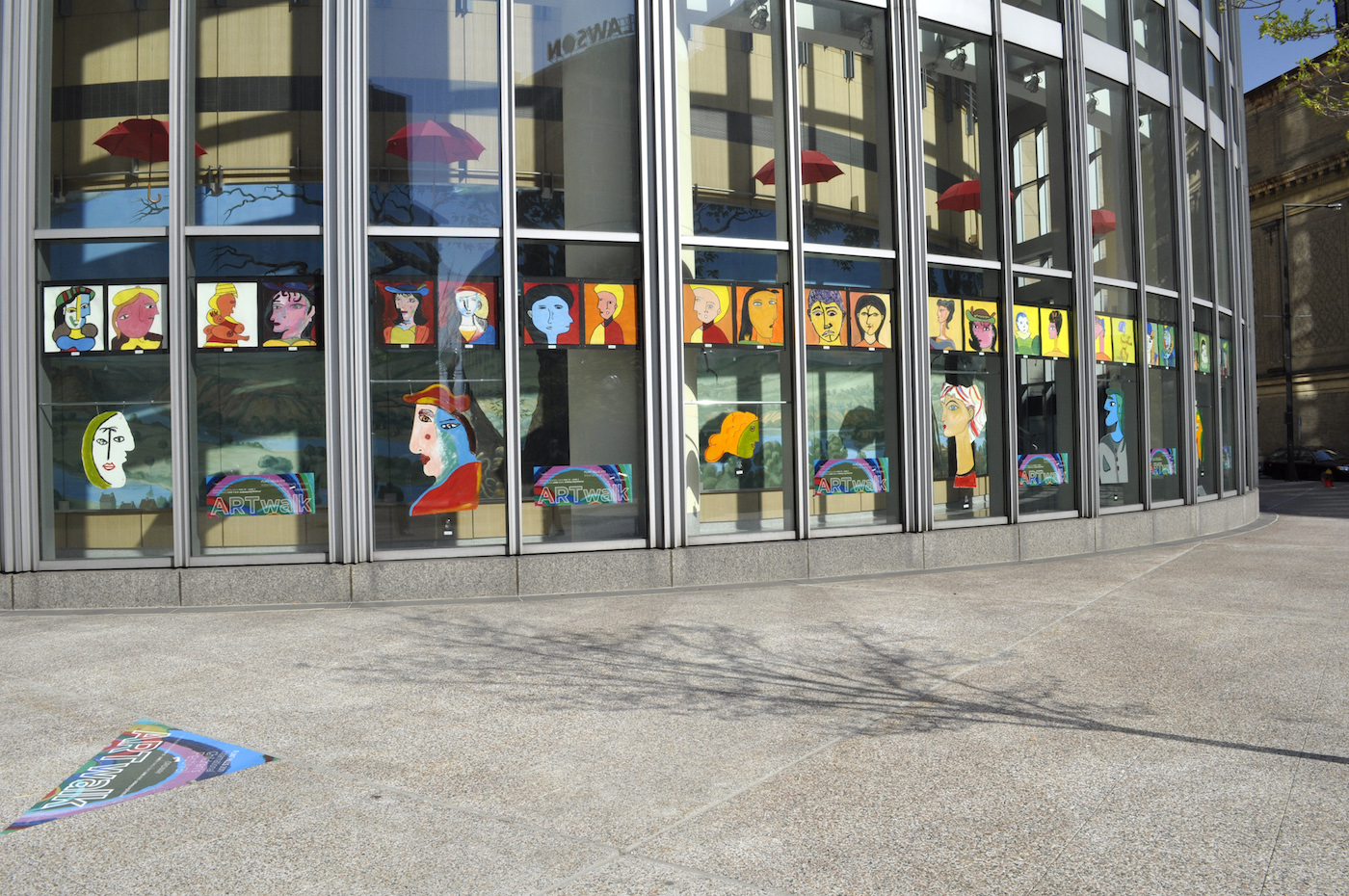 A window display of colorful portraits