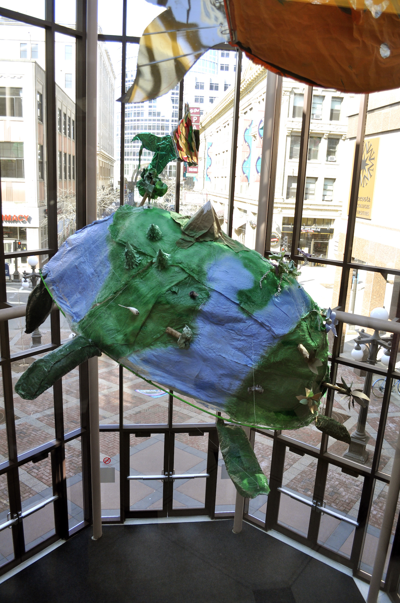 Image of a large sculptural turtle suspended in an atrium